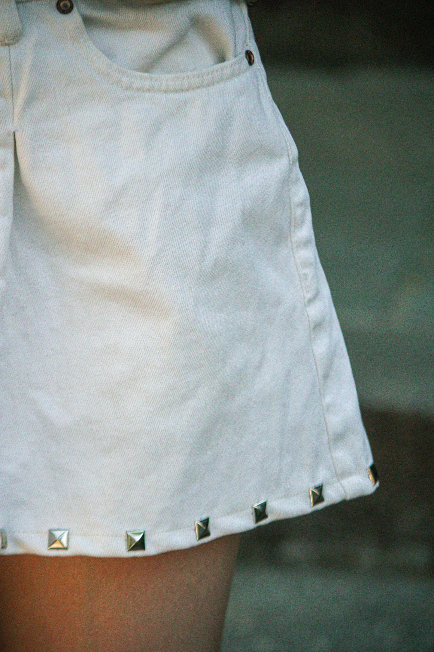 stud pleated white denim mini